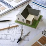 Architect design concept of house model on blueprint with construction drawing